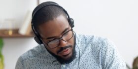 a black man with headphones listening to music