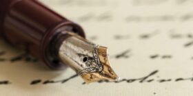 an inkwell pen sitting on a letter