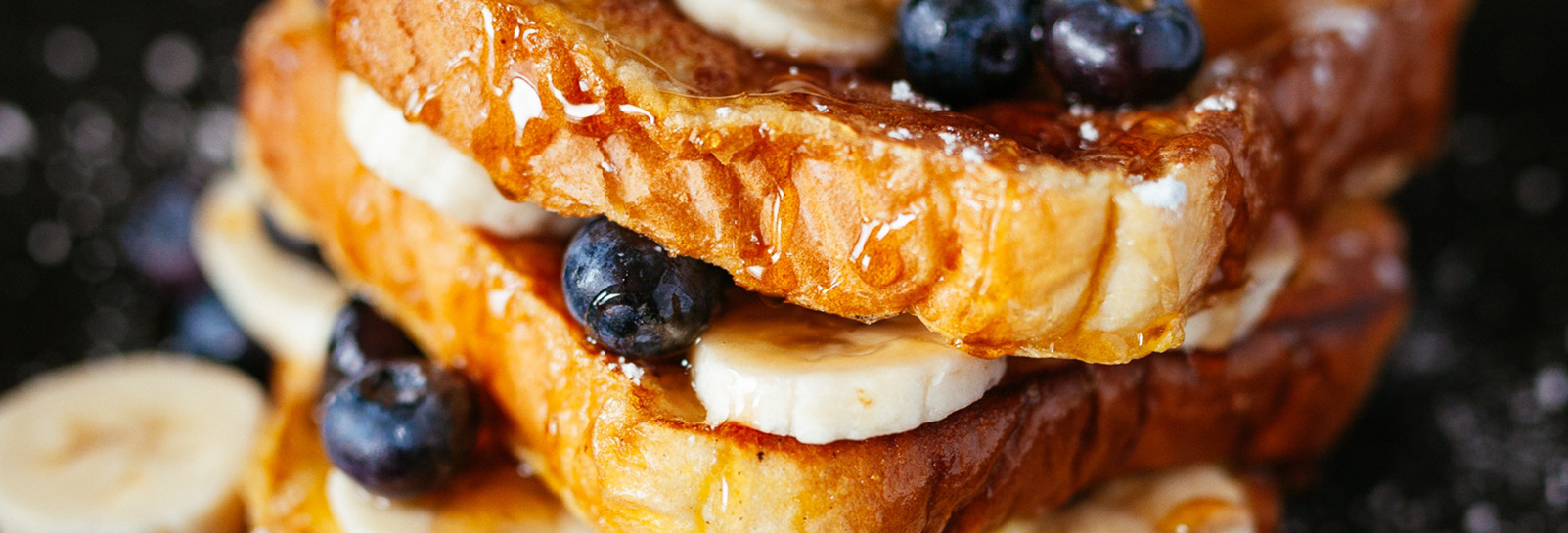 a stack of french toast, blueberries, and bananas