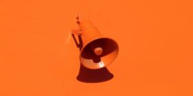 an orange megaphone on an orange background