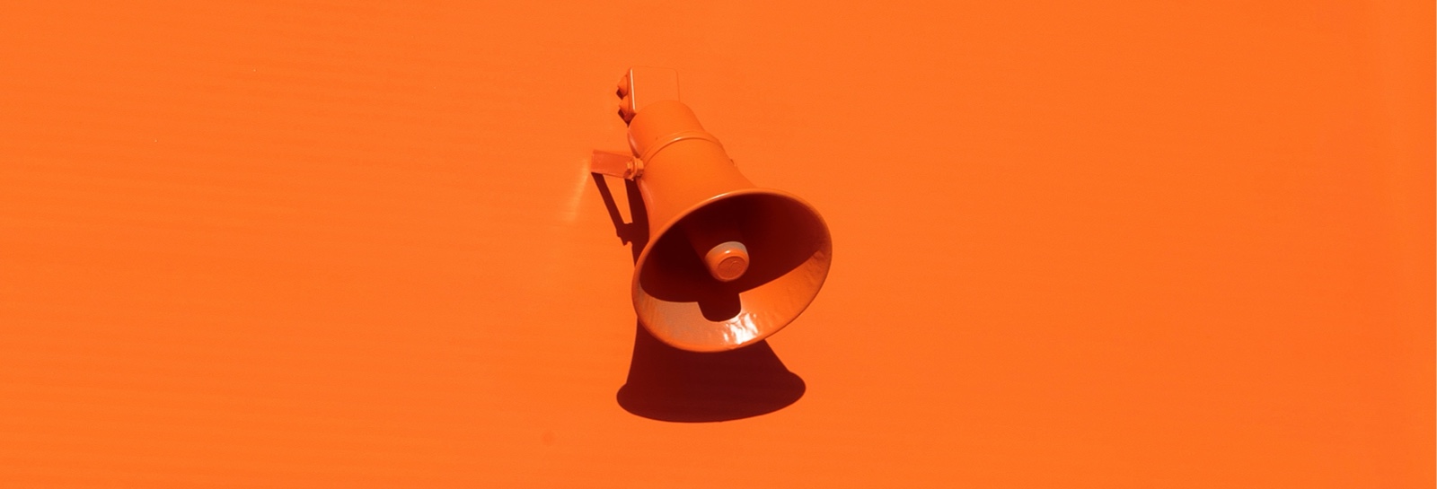 an orange megaphone on an orange background