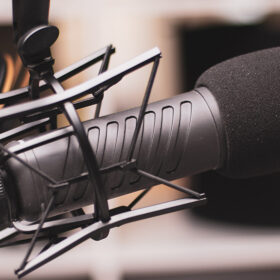 Close up of podcast set up with a microphone and headphones